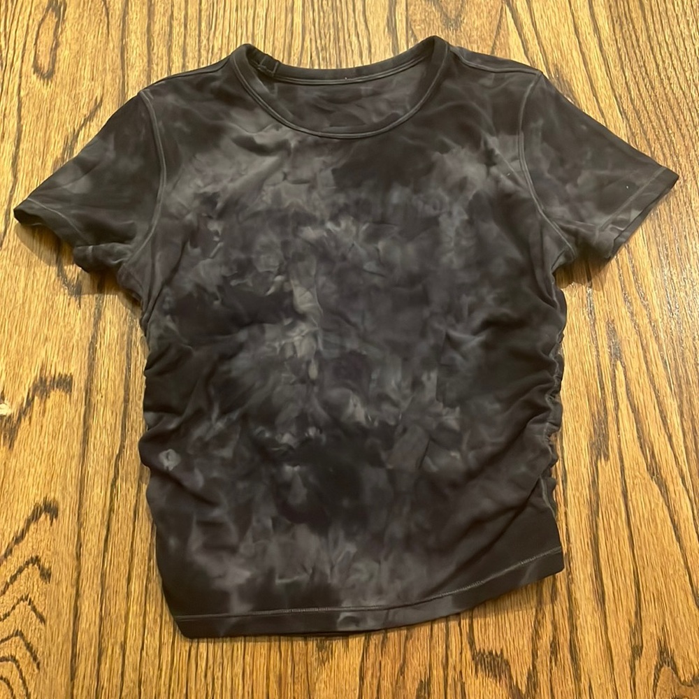 A Lululemon camo shirt with short sleeves.